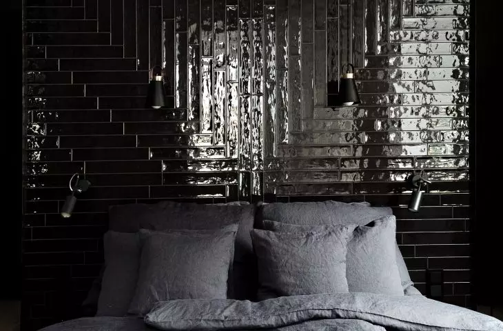 The dark wall behind the bed