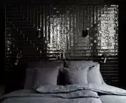 The dark wall behind the bed