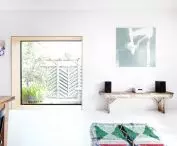 large glazing surrounded by a deep wooden frame adds a modern touch to the interior