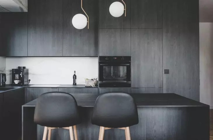 the kitchen is kept in dark colors