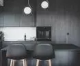 the kitchen is kept in dark colors