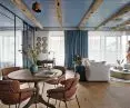 The bedroom is separated from the living room by a glass window