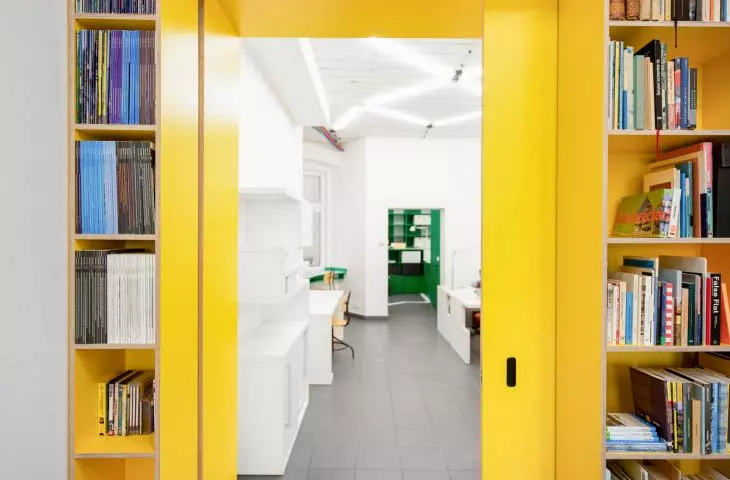 Yellow sliding doors separate the conference room from the rest of the office