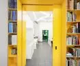Yellow sliding doors separate the conference room from the rest of the office