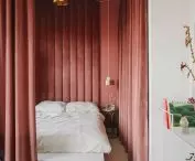 Behind the heavy curtain is a bedroom