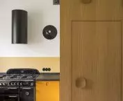 Black round lamps in the kitchen designed by Gianluigi Gorgoni