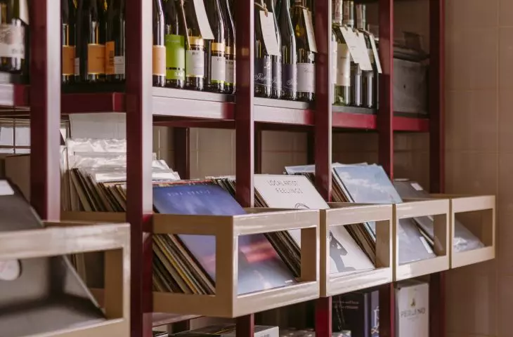 Shelves full of wine and vinyl records