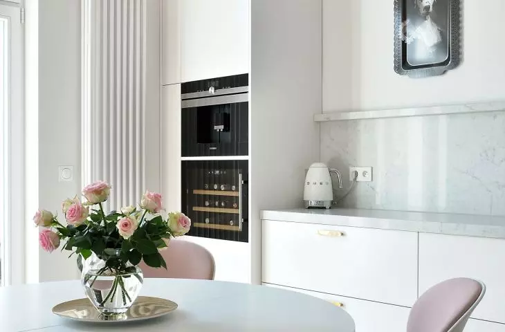the wall of the kitchen is decorated with an unusual portrait