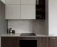The upper cabinets in the kitchen are white, making them visually seem lighter