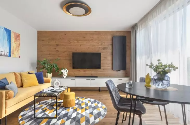 The living room is characterized by a floor that goes into the wall