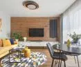 The living room is characterized by a floor that goes into the wall