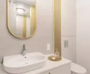 Oval mirror breaks the rhythm of vertical lines