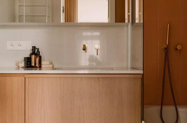Gold accents in the bathroom are lamps and fixtures
