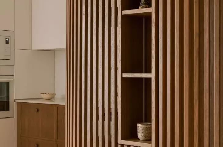 Wooden cabinet introduces a vertical rhythm