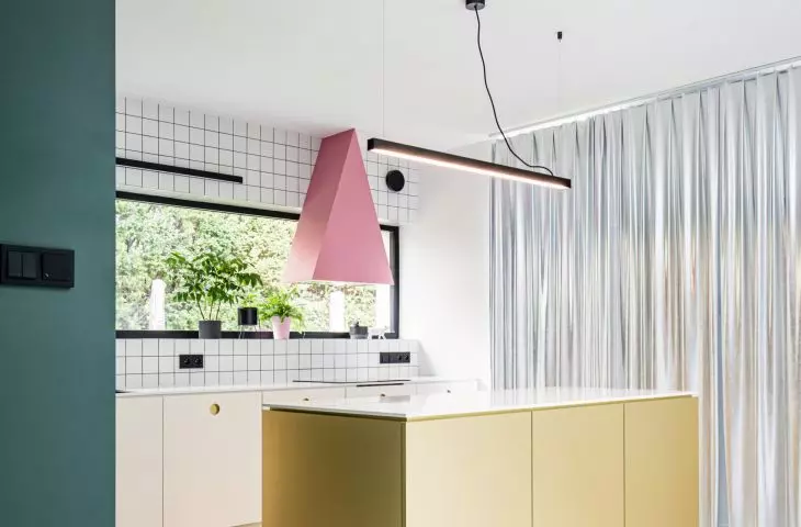 gold island and pink hood in the kitchen