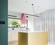 gold island and pink hood in the kitchen