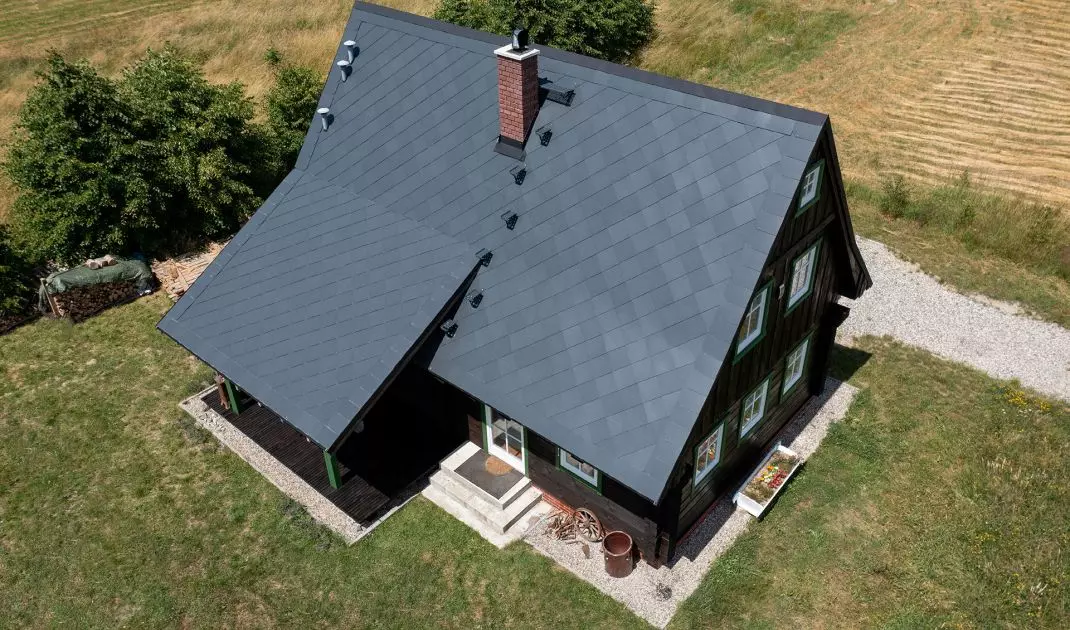 Dom w Nowym Waliszowie, dach wykonany z płytek Cedral w kolorze grafitowym, krycie francuskie
