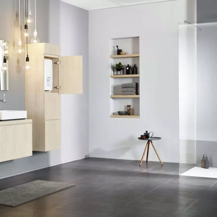Bathroom arrangement with D-series e-heater hidden in the cabinet