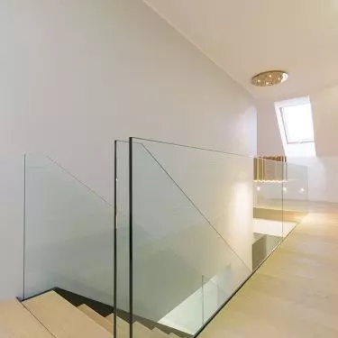 Powder-coated steel cheek stairs, steps made of varnished oak. Glass balustrade. Realization private house