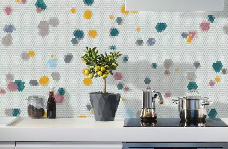 Spotty Thin mosaic on the wall between kitchen cabinets