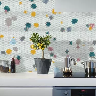 Spotty Thin mosaic on the wall between kitchen cabinets