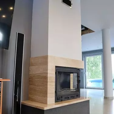 Fireplace surround in natural Breccia Sarda marble and Padang Dark granite