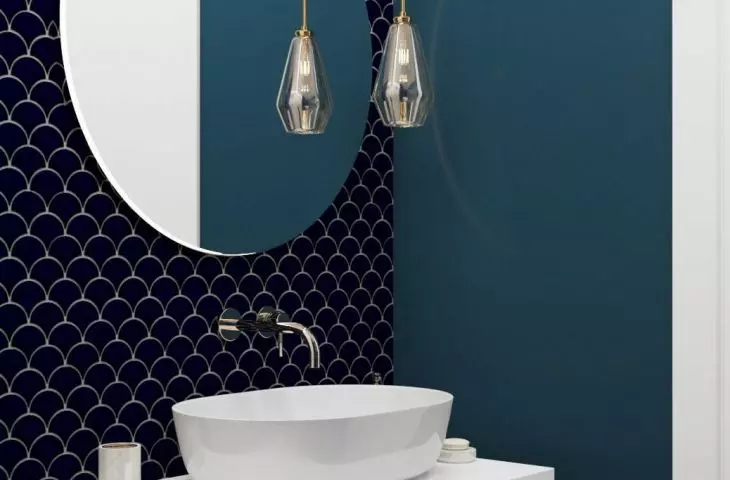The blue is the paint and fish scale tiles on some walls and the tiles on the bathroom floor.