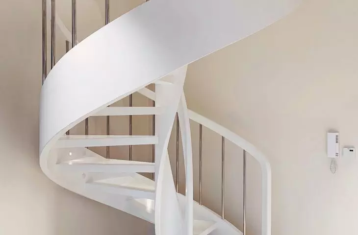 White painted ash staircase with steel balusters with discreet lighting
