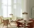 From left, A Conversation Piece and The Reader armchairs, Hang Out table, Time Flies chairs, Clava Dine Wood pendant lamp