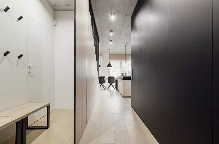 The interior is dominated by black, gray concrete and wood