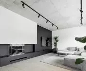 The living room has a large wall for a projector