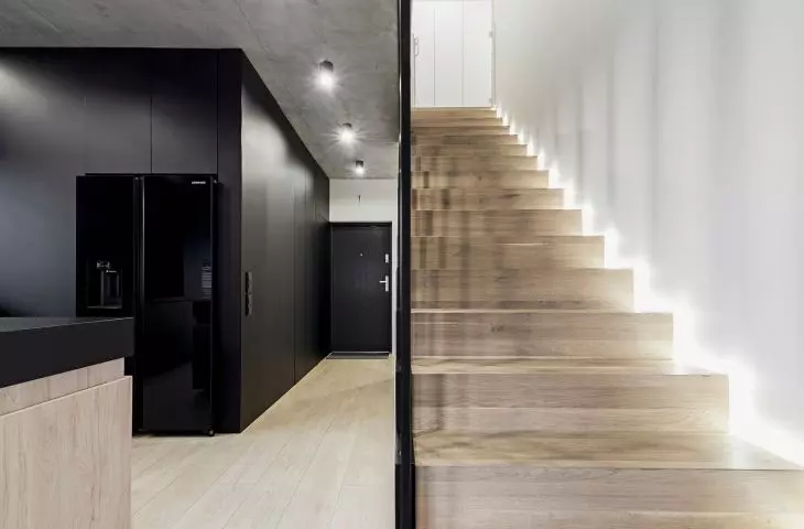 A wooden staircase leads to the first floor