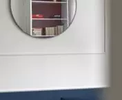 A round mirror in the living room optically enlarges the space