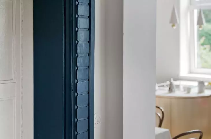 decorative band around the wooden front door