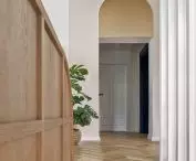 Stairs and wooden laths between the kitchen and living room