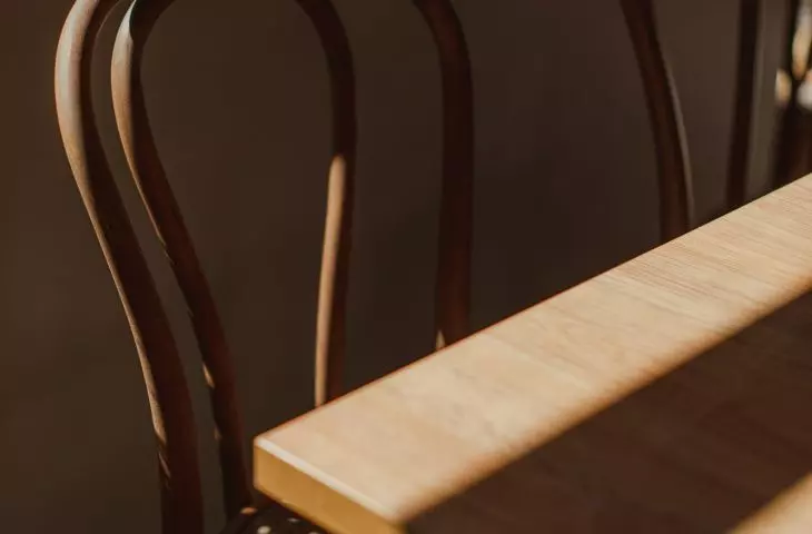 The seats of the wooden chairs are openwork