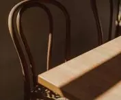 The seats of the wooden chairs are openwork