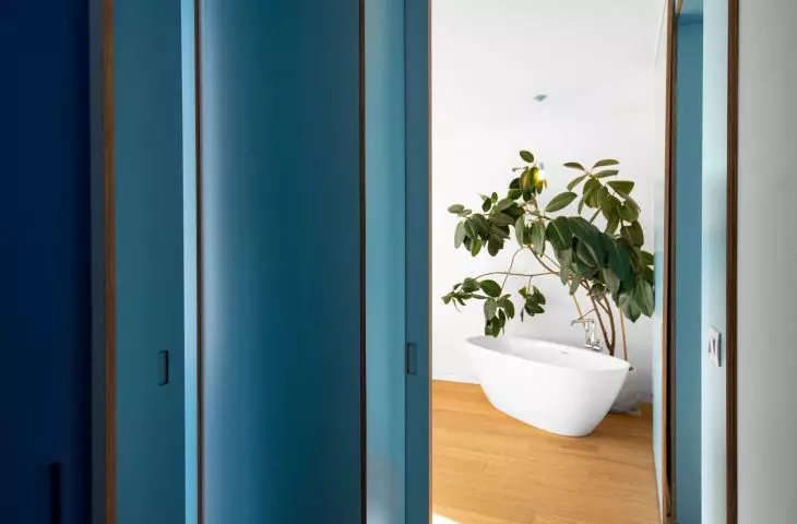 view of bedroom with free-standing bathtub