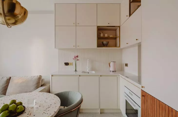 kept in bright colors, the kitchen seems to be a perfect background for the play of warm spots of sun rays coming through the windows