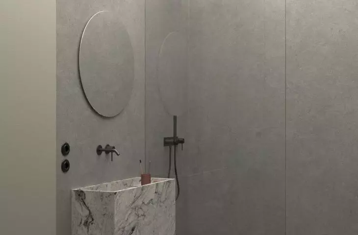 Design of an apartment in Zabłocie, the bathroom is dominated by gray tones and granite