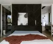 A dressing room and bathroom hide behind the bedroom wall