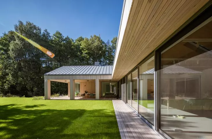 Covered terraces are located along the southwest side of the house