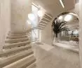 Arches, textures and light wood tones allude to the Mediterranean climate