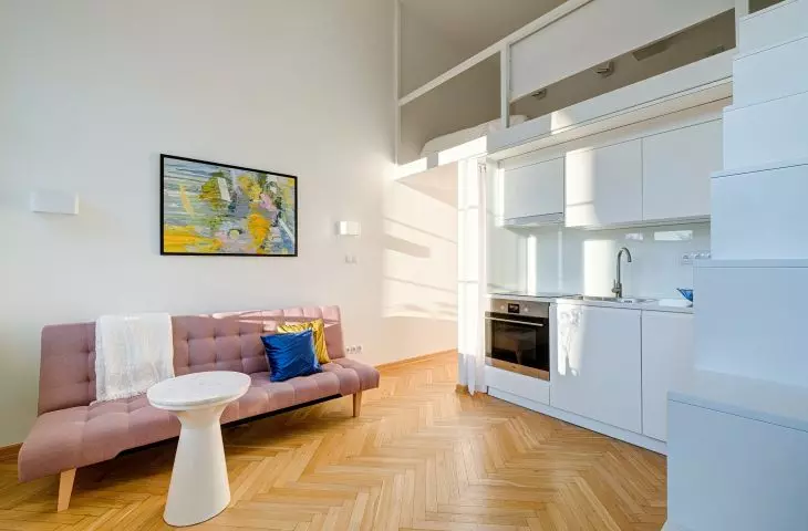The space is brightened by the light coming in through the large windows