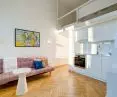 The space is brightened by the light coming in through the large windows