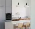 Kitchen with blue cabinetry and marble kitchen island