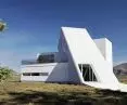 Some of the walls of the house are sloping and are emphasized by the bending lines of the sheet metal