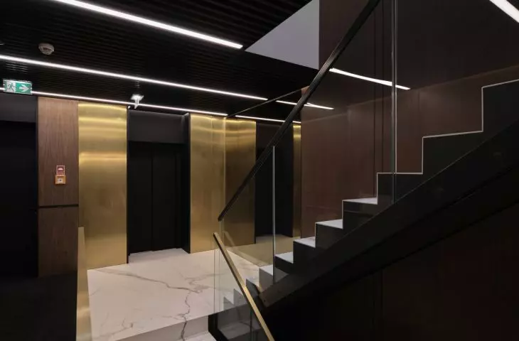 the interior is dominated by dark colors broken with gold accents