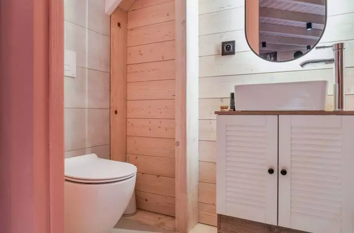 the bathroom is hidden under the stairs