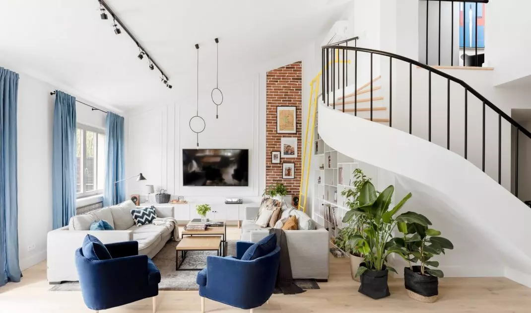 The dominant element in the living room is the fan staircase